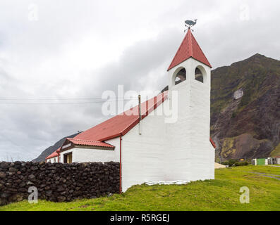 Saint Joseph's Catholic church in Edinburgh of the Seven Seas town, Tristan da Cunha, the most remote island. Red roof and bellower, a whale and cardi Stock Photo