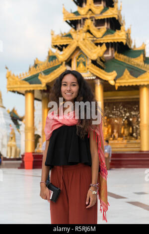 Vertical picture of young asian eyes woman at Shwedagon Pagoda, important religous site in Yangon, Myanmar Stock Photo