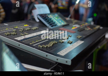 Soundman working on the mixing console. Hands on the sliders. Stock Photo