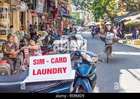 Hanoi, Vietnam - CIRCA October 2015: street stall offers sim cards and laundry services to tourists on the streets of Hanoi. Stock Photo