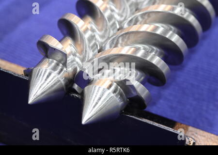 Screw press parts for plastic injection machine ; selective focus Stock Photo