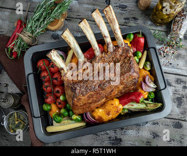 Grilled roasted rack of lamb,veal with vegetables on the baking sheet Stock Photo