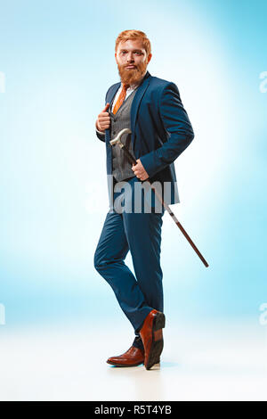 The barded man in a suit holding cane. Stock Photo