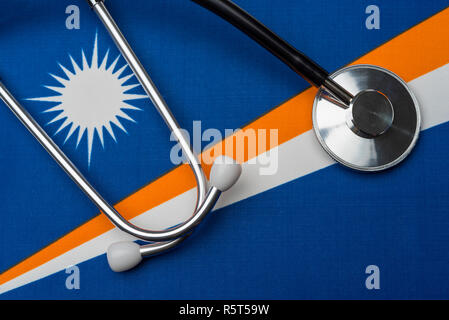 Marshall Islands flag and stethoscope. The concept of medicine. Stethoscope on the flag as a background. Stock Photo