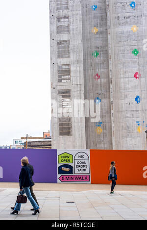 Construction site of Google’s new King’s Cross HQ headquarters  designed by Bjarke Ingels Group and Heatherwick Studios with people walking in front Stock Photo