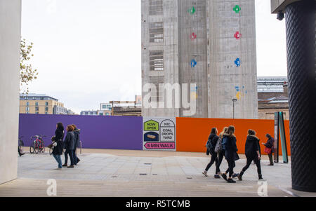 Construction site of Google’s new King’s Cross HQ headquarters  designed by Bjarke Ingels Group and Heatherwick Studios with people walking in front Stock Photo