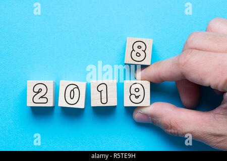 Hand changing wood cube from 2018 to 2019 Stock Photo