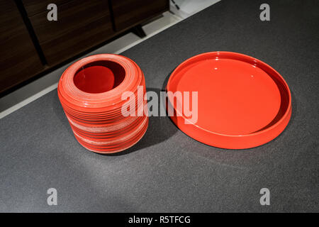 Red tableware on loft stylish table background Stock Photo