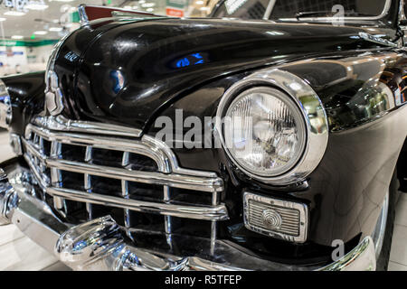 Old black car close up with grille and headlamp on exhibition Stock Photo