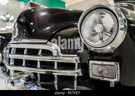 Old black car close up with grille and headlamp on exhibition Stock Photo