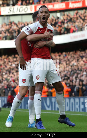 Arsenal's Pierre-Emerick Aubameyang (right) celebrates scoring his side's first goal of the game during the Premier League match at Emirates Stadium, London. Stock Photo