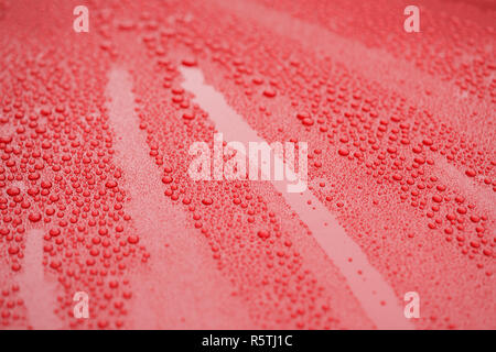 Closeup waterdrops on red ceramic coated paint surface Stock Photo