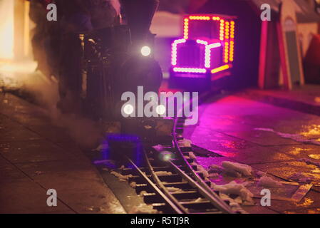 Miniature Steam Locomotive Attraction at Night Front View Stock Photo