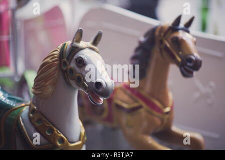 White and Brown Carousel Horses at Night Closeup Stock Photo