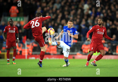 Liverpool's Andrew Robertson (left) and Everton's Richarlison (right) battle for the ball during the Premier League match at Anfield, Liverpool. Stock Photo