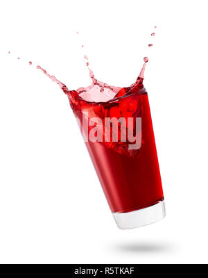 falling glass of red juice or berry compote with splashes isolated on white background Stock Photo