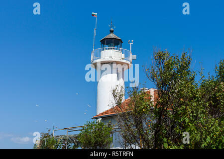 Lighthouse against the blue sky. The Island of St. Anastasia. Burgas Bay. Black Sea. Bulgaria. Stock Photo
