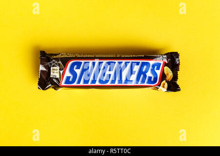 Ukraine, Kiev March 29, 2018. Chocolate Snickers on a yellow background. Snickers bars are produced by Mars Incorporated. Stock Photo