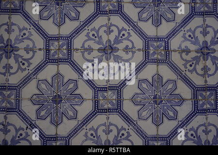 Lisbon / Portugal - May 2017: Portuguese traditional painted tin-glazed ceramic tiles Azulejos decorated with beautiful blue floral ornament Stock Photo