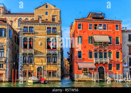 Old venetian palaces and a narrow street channel or rio between  Stock Photo