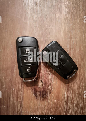 Close up Image of two car keys on a wooden table top down view Stock Photo