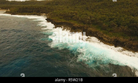 Rocky coast line in time stormy weather on island Siargao. Aerial view sea rocky coast, waves breaking to the rocky shore. Rocky coastline. Big waves crushing on the shore. Philippines. Travel concept. Stock Photo