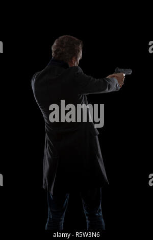 silhouette of a man with a gun Stock Photo