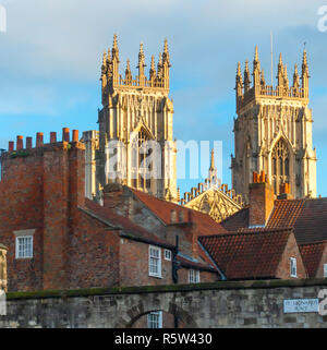 Towers of York Minster above old red roof tops from St Leonards Place York Stock Photo