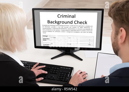 Businesspeople Analyzing Graph On Computer Stock Photo