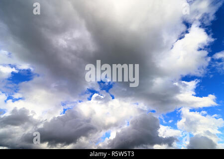 big thick white and dark clouds in the blue sky. strong cloud in the sky Stock Photo