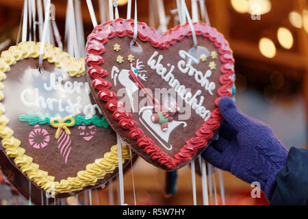 German Christmas gingerbreads on a Christmas market with the words Merry Christmas in English and German Stock Photo