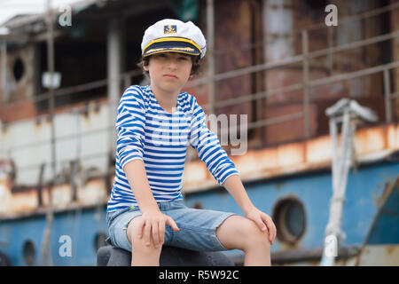 Portrait of a boy in a vest (Telnyashka) and captain's cap. Stock Photo