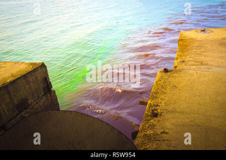 riverscape of large drainage steel pipe background. Stock Photo