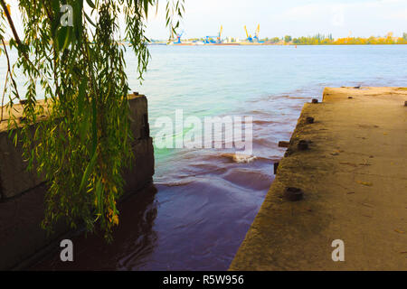 riverscape of large drainage steel pipe background. Stock Photo