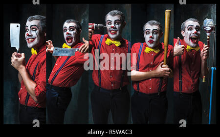 The scary clown holding a knife on dack. Halloween concept Stock Photo