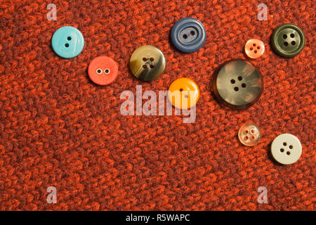 Various sewing buttons on textile background Stock Photo