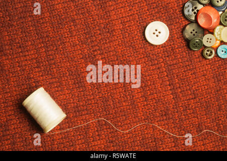 Various sewing buttons on textile background Stock Photo