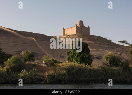 View from Nile river of Aga Khan mausoleum tomb on hill top in Aswan Egypt Stock Photo