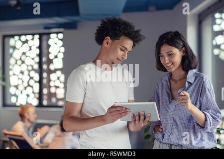 business, technology, startup and people concept - happy creative team with tablet pc computers in office Stock Photo