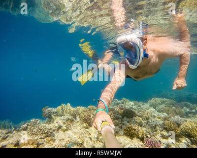 man snorkel in shallow water on coral fish Stock Photo