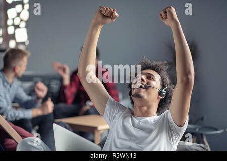 Laughing african american hipster software developer at computer at office of startup company Stock Photo