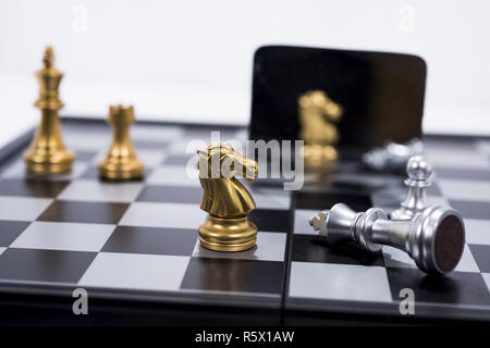 Chess Board isolated on white background. Golden and silver figures. Stock Photo