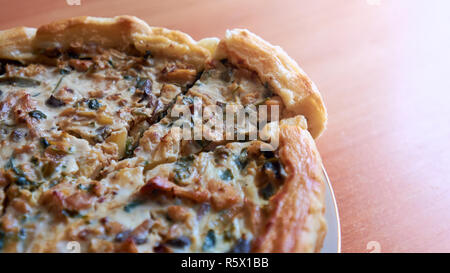 Homemade cake with mushrooms, chicken and vegetables on a wooden table. Background with copy space. Stock Photo
