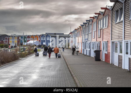 HELGOLAND, GERMANY - DECEMBER 18, 2016: People and shops in the Harbor of Helgoland island on a cloudy day, Germany Stock Photo