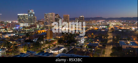 Dusk comes as night falls on the buildings in the downtown urban core of Phoenix Arizona Stock Photo