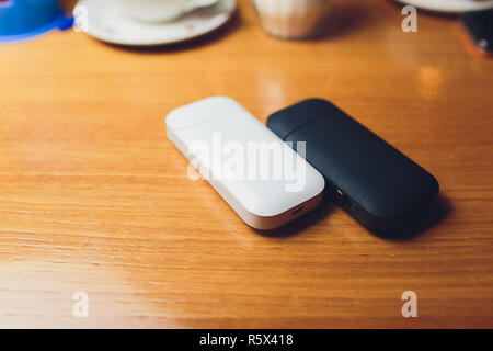 Photo product IQOS 2.4 plus heat control technology electronic cigarette and FIIT change up on wood background Stock Photo