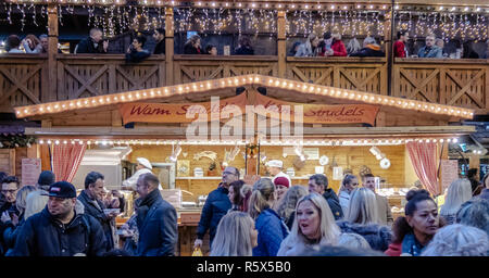 02 December 2018, Manchester Christmas Market, People enjoy food from the Warm Strudel stall and drinks in the bar above. Stock Photo