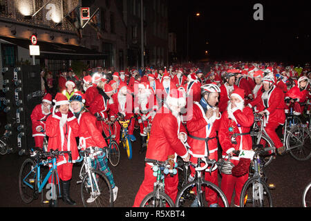 Cork, Ireland. 02nd December, 2018. Some of the 400 Santa's getting ready  to take part in the Santa Cycle to raise funds for the medical support group Straight Ahead which provides surgery, support and medical equipment for children with orthopaedic conditions in Cork, Ireland. Credit: David Creedon/Alamy Live News Stock Photo