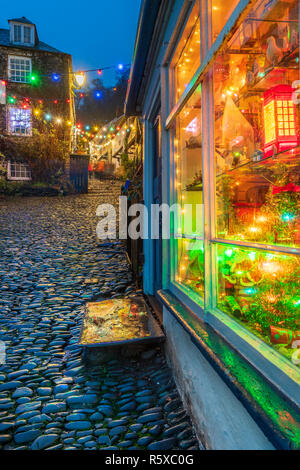 Clovelly, Devon, UK. 2nd Dec, 2018. The cobbled streets and quaint harbour in the picturesque North Devon village of Clovelley was a stunning backdrop for a festive light celebration on Sunday 2nd December. Fortunately, the predicted rain and high winds stayed away as the crowd enjoyed Xmas carols, singers and a brass band followed by lighting the Xmas lights and a firework display. Credit: Terry Mathews/Alamy Live News Stock Photo