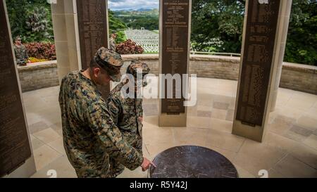 PORT MORESBY, Papua New Guinea (April 18, 2017) U.S. Marine Cpl. Alan Lam and U.S. Navy Petty Officer 3rd Class Bryan Casado explore a monument during a cultural tour at the Port Moresby (Bomana) War Cemetery as part of a theater security cooperation engagement, April 18. The cemetery contains the gravesites of Papuan, Australian, and New Guinea Soldiers who died during WWII in the former territory of Papua and Bougainville Island. Lam is a combat engineer and Casado is a corpsman with Combat Logistics Battalion 11, 11th Marine Expeditionary Unit. Stock Photo